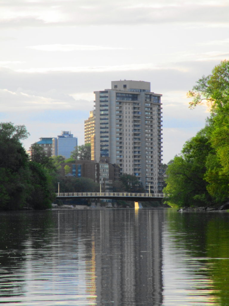 The evening sun casts its last rays on the Rideau River and the Adawe Crossing footbridge.