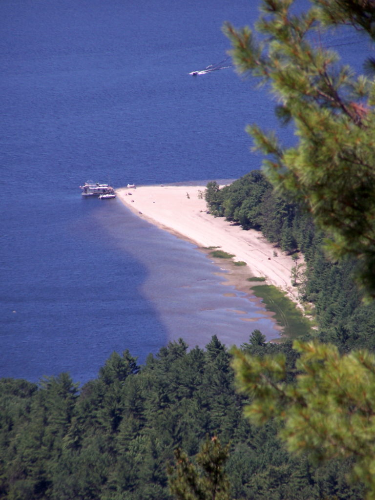 From far above on Mount Martin, the sandy beach and shoals of Houseboat Point can be seen reaching out into the blue Ottawa River