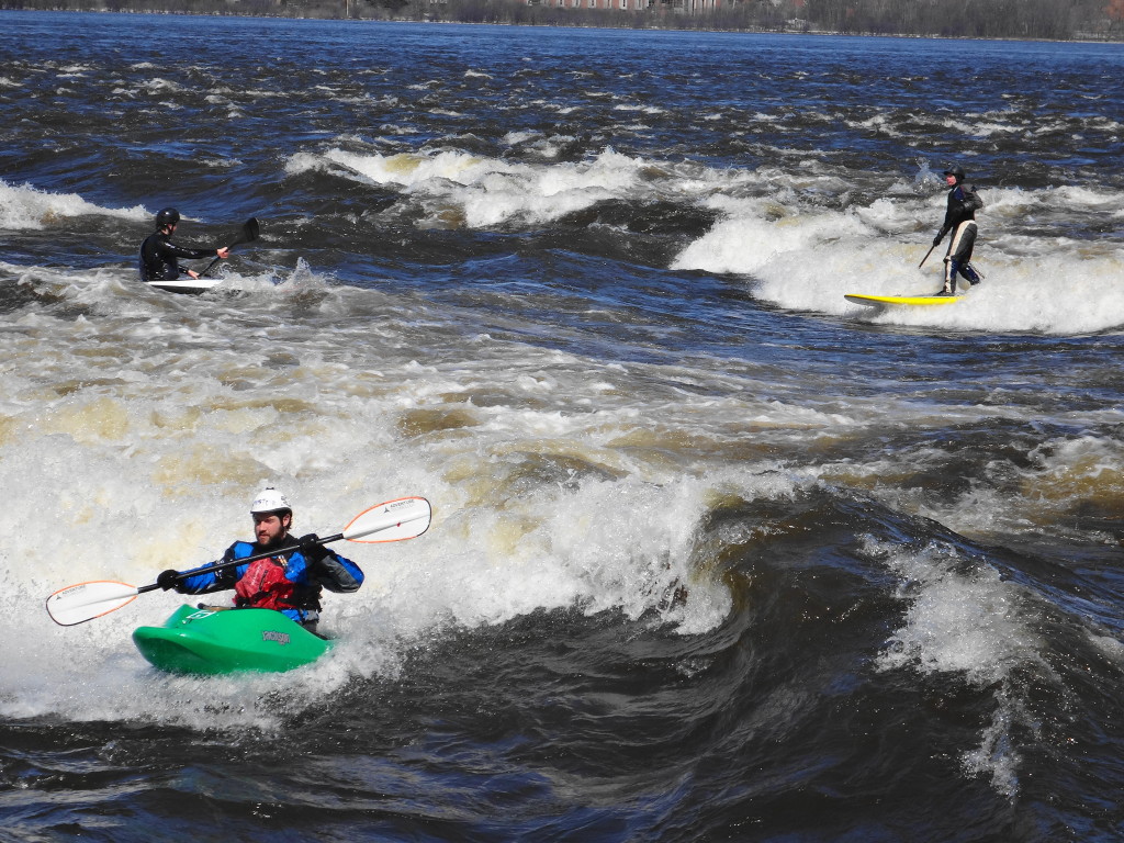 A kayaker and stand-up paddleboarder ride the whitewater at Bate Island