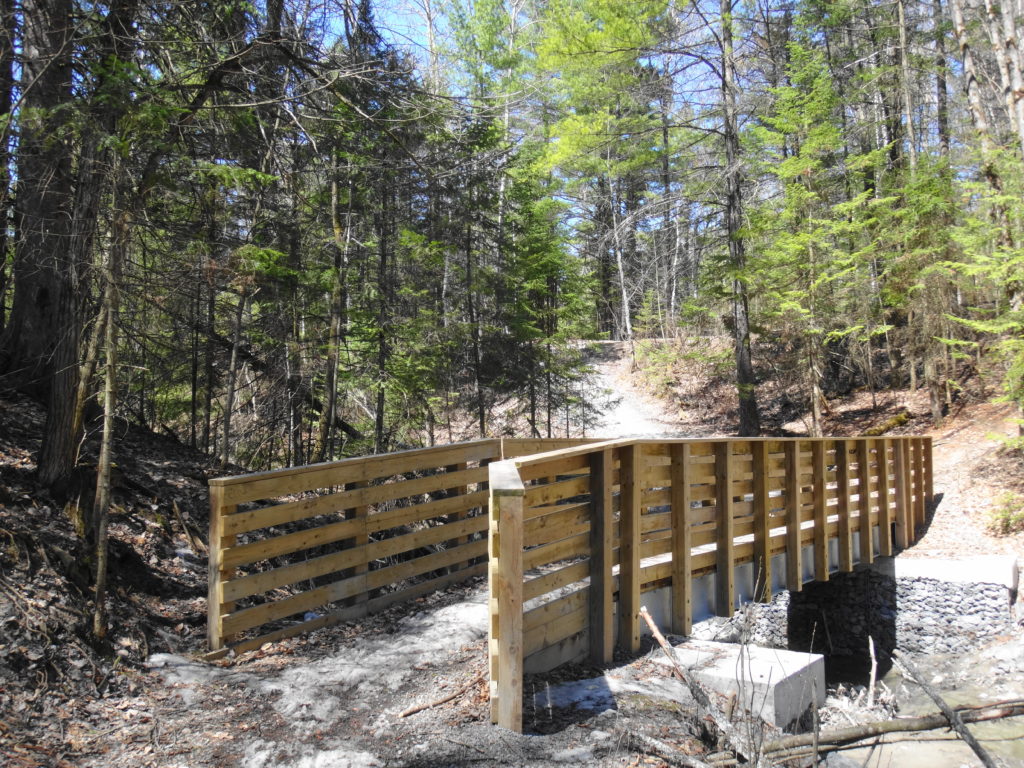 A footbridge for a multi-use trail crosses Bilberry Creek.